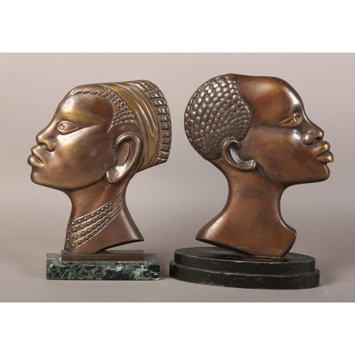 57 - TWO EARLY 20TH CENTURY BRONZE PROFILES OF AN AFRICAN TRIBESMAN AND WOMAN, after Hagenau, coppered pa... 