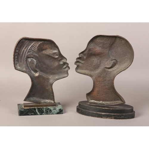 57 - TWO EARLY 20TH CENTURY BRONZE PROFILES OF AN AFRICAN TRIBESMAN AND WOMAN, after Hagenau, coppered pa... 