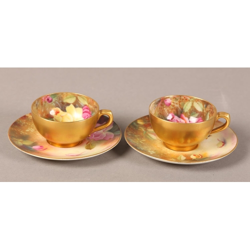 83 - A PAIR OF ROYAL WORCESTER CABINET CUPS AND SAUCERS, painted with yellow and pink roses, signed Twin,... 