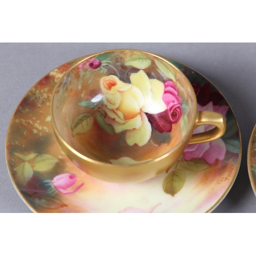 83 - A PAIR OF ROYAL WORCESTER CABINET CUPS AND SAUCERS, painted with yellow and pink roses, signed Twin,... 