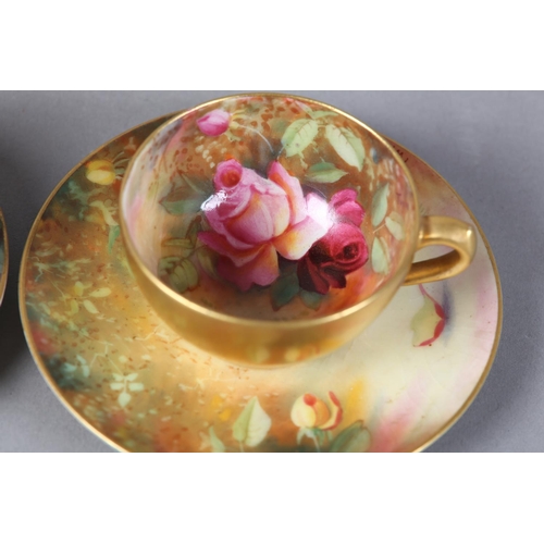 83 - A PAIR OF ROYAL WORCESTER CABINET CUPS AND SAUCERS, painted with yellow and pink roses, signed Twin,... 