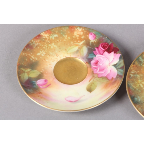 83 - A PAIR OF ROYAL WORCESTER CABINET CUPS AND SAUCERS, painted with yellow and pink roses, signed Twin,... 