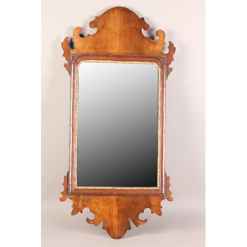 406 - A MID 18TH CENTURY WALNUT WALL MIRROR having a fret-cut frame, rectangular glass with parcel gilt sl... 