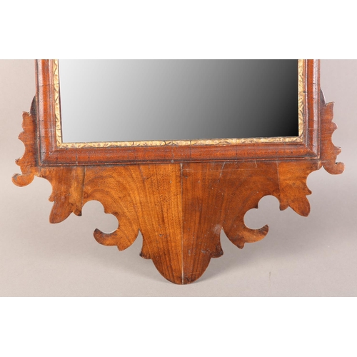 406 - A MID 18TH CENTURY WALNUT WALL MIRROR having a fret-cut frame, rectangular glass with parcel gilt sl... 