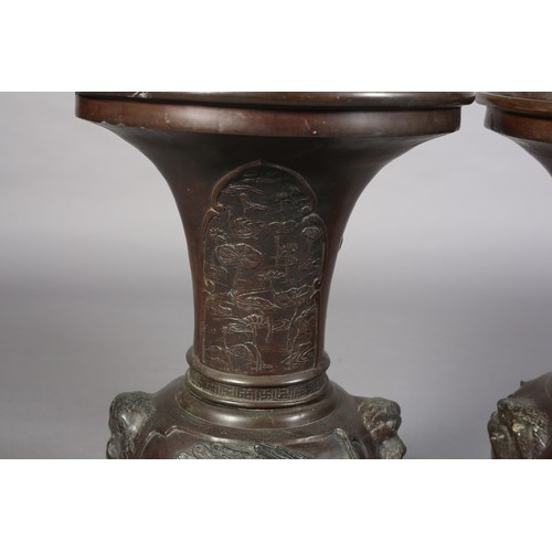 107 - A PAIR OF JAPANESE BRONZE VASES, MEIJI PERIOD, of baluster outline, the neck cast with opposing pane... 