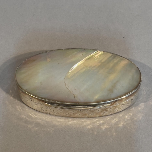 43 - A late 19th century silver and mother of pearl; snuff box, oval, the sides embossed with a trellis p... 