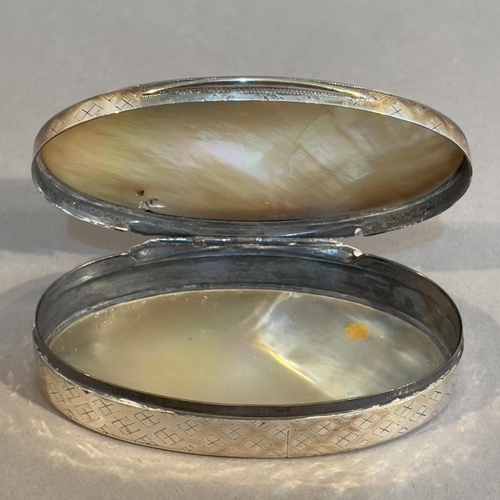 43 - A late 19th century silver and mother of pearl; snuff box, oval, the sides embossed with a trellis p... 