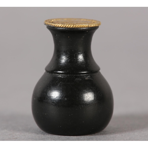 57 - An ebony seal with a George III one-third Guinea Matrix (the coin c1797-1813), 3cm high (Shipping ca... 