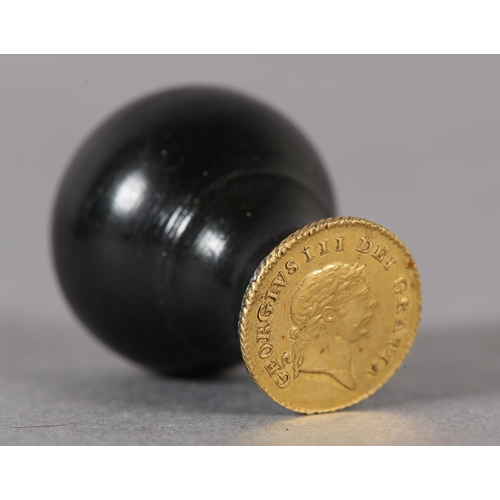 57 - An ebony seal with a George III one-third Guinea Matrix (the coin c1797-1813), 3cm high (Shipping ca... 