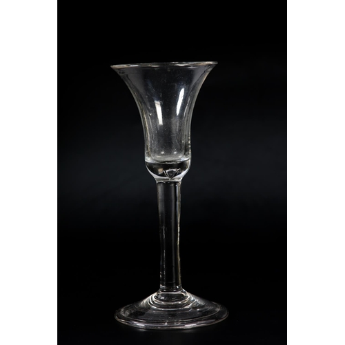 60 - An 18th century wine glass, c1780, the ogee bowl etched with flower and leaves, on plain stem, domed... 