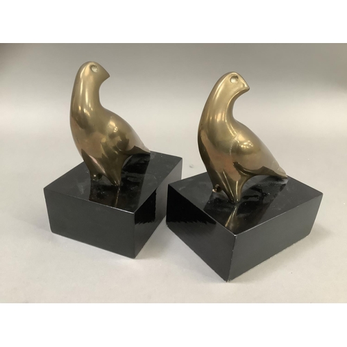 13 - A pair of brass hawk bookends on ebonised, rectangular plinths, 13cm wide x 10cm deep x18cm high