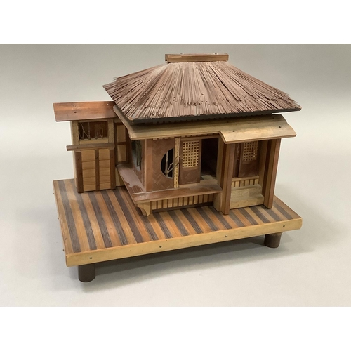 14 - Model of a Japanese house raised on a platform and with bamboo feet. 23.5cm wide x 15.5cm deep x 20c... 