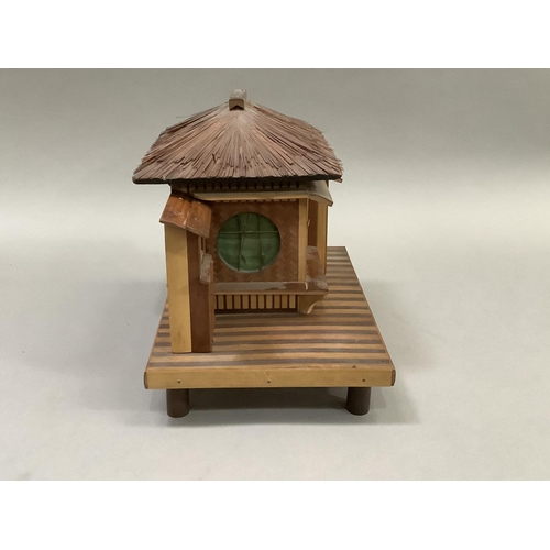 14 - Model of a Japanese house raised on a platform and with bamboo feet. 23.5cm wide x 15.5cm deep x 20c... 