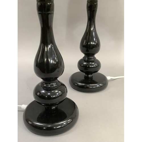 420 - A pair of black perspex moulded retro style lamps having black, cream and red shades, 35cm high