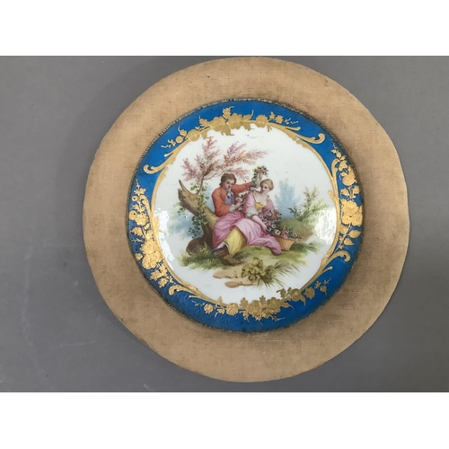 7 - A Sevres style porcelain plaque, painted with a romantic scene of a lovers in a landscape within a b... 