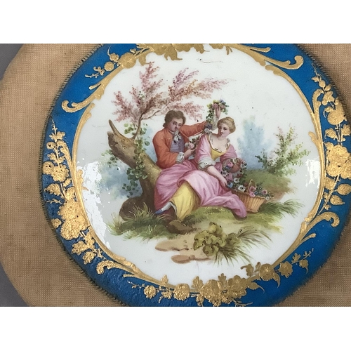 7 - A Sevres style porcelain plaque, painted with a romantic scene of a lovers in a landscape within a b... 