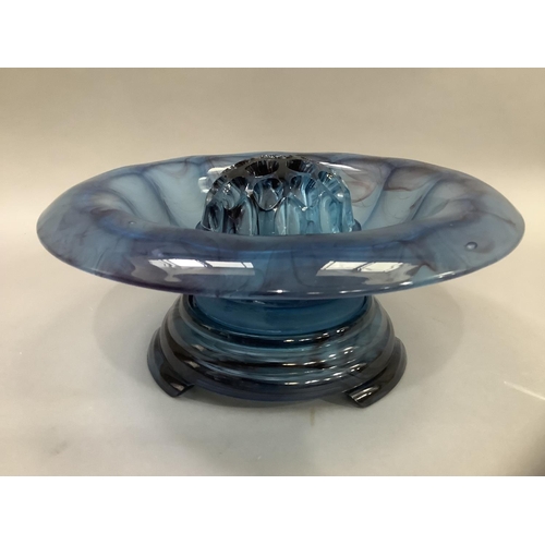 9 - An Art Deco blue cloud glass bowl with broad everted rim on stand, with central posy, 35cm wide