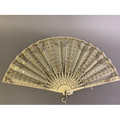 28 - Three 20th century fans: the first, in white mother of pearl, a pastiche of an 18th century fan, the... 