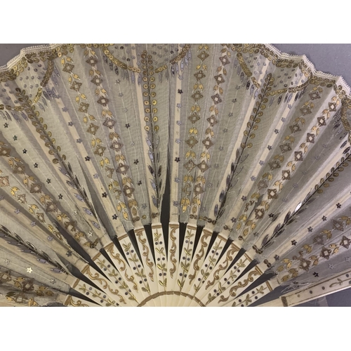 28 - Three 20th century fans: the first, in white mother of pearl, a pastiche of an 18th century fan, the... 