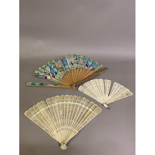 132 - A Chinese Qing Dynasty asymmetrical carved wood Mandarin fan, 19th century, the leaf with robed figu... 