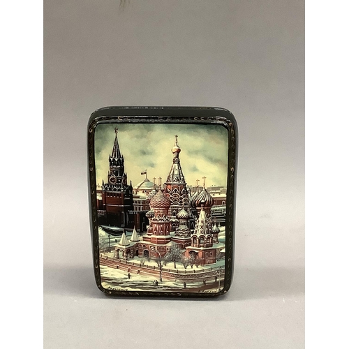 17 - A modern Russian lacquered hinged box, the lid hand painted with a winters scene of St Basil's cathe... 