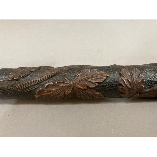 48 - A large 19th Century Black Forest pipe, the bowl and stem carved with deer in a forest with tree and... 