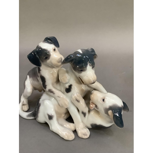 70 - A Bing and Grondahl figure group of three playing terrier pups, no.1815 together with another figure... 