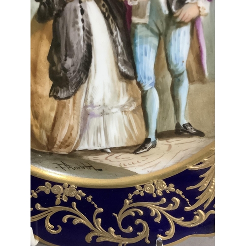 85 - A pair of late 19th century 'Sevres' plates, painted with a couple, signed, within a gros bleu and g... 