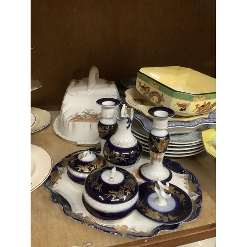 115 - A collection of ceramics comprising a musical fruit dish, cake stands, cheese dish and cover, blue a... 