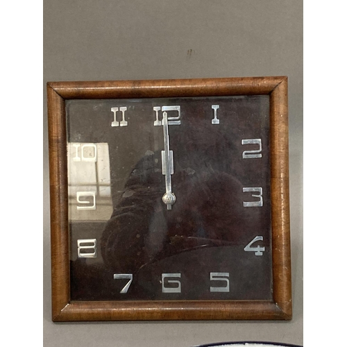 33 - An Art Deco walnut mantle clock of square outline with chrome Arabic numerals and hands, with back s... 