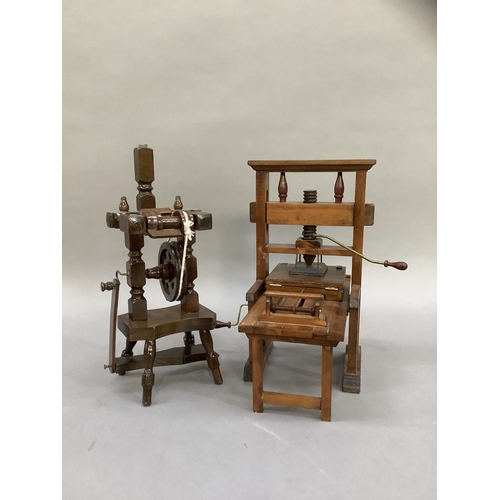 40 - A model printing press and a spinning wheel