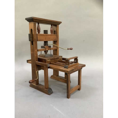 40 - A model printing press and a spinning wheel