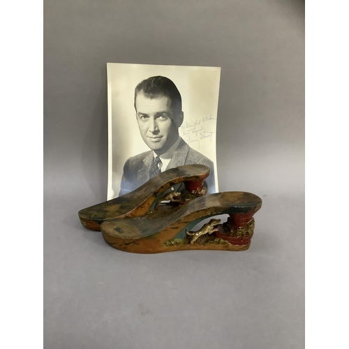 44 - A pair of WWII painted wooden sandles and a photograph of James Stewart with inscription 'To Winifre... 