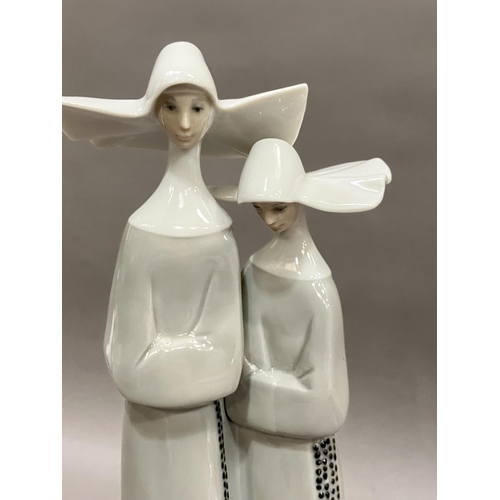 98 - A large Lladro figure group of two nuns, 32cm high together with a Bohemian white glass, ruby cased ... 