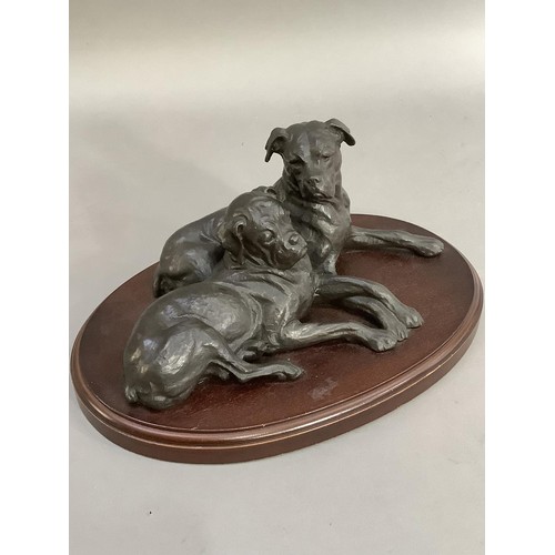 74 - A bronze effect group of two boxer dogs on an oval plinth, 30cm wide x 15cm high