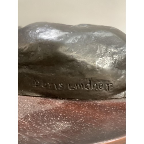 74 - A bronze effect group of two boxer dogs on an oval plinth, 30cm wide x 15cm high