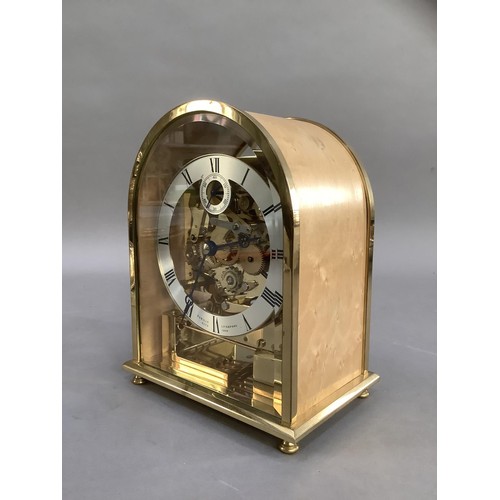 84 - A domed brass and birdseye maple mantel clock with exposed movement, silvered chaptering with Roman ... 