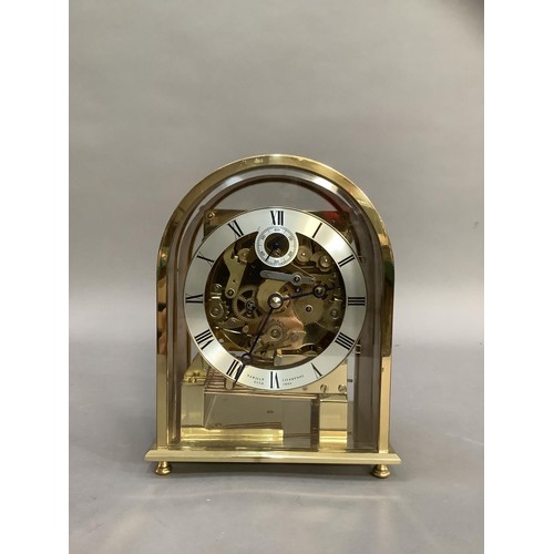 84 - A domed brass and birdseye maple mantel clock with exposed movement, silvered chaptering with Roman ... 