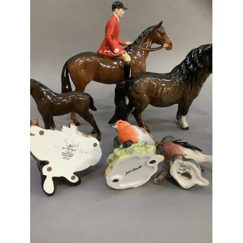 88 - A Beswick huntsman and horse, a Shetland pony and a donkey foal, a chaffinch and a robin beside a tr... 