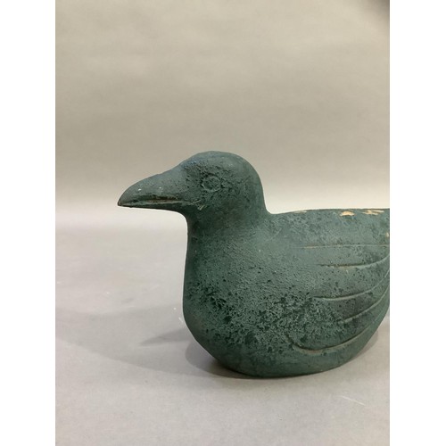 93 - A naive carving of a bird finished in sea green, 28cm long x 12cm high