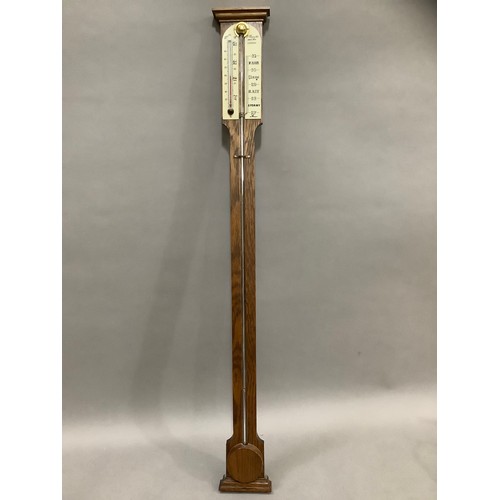 443 - An oak barometer/thermometer by Comitti and Son Ltd London, 20th century, 92cm long