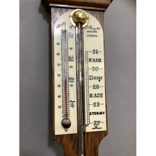 443 - An oak barometer/thermometer by Comitti and Son Ltd London, 20th century, 92cm long