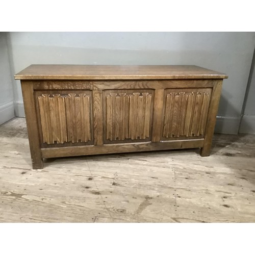 421 - An oak ottoman with linen fold front and on stile feet