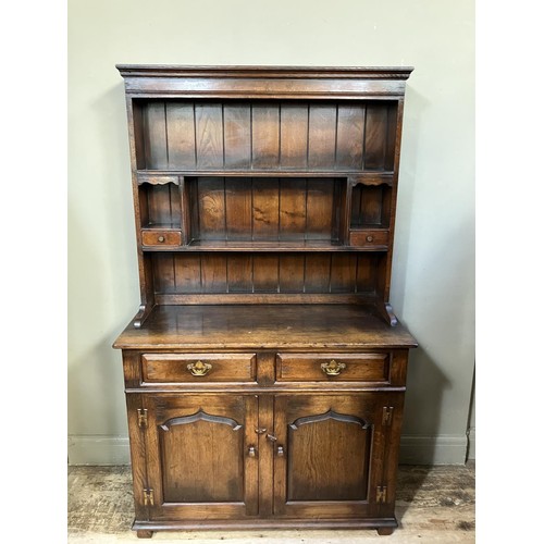 429 - A Titchmarsh and Goodwin dresser and rack having a moulded cornice over a planked back with shelves,... 