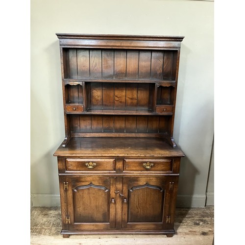 429 - A Titchmarsh and Goodwin dresser and rack having a moulded cornice over a planked back with shelves,... 