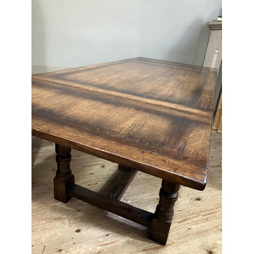 430 - A Titchmarsh and Goodwin oak drawer leaf extending dining table on turned legs joined by an 'H' stre... 