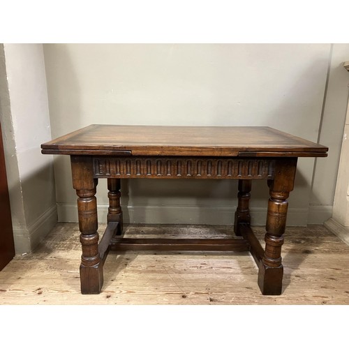 430 - A Titchmarsh and Goodwin oak drawer leaf extending dining table on turned legs joined by an 'H' stre... 