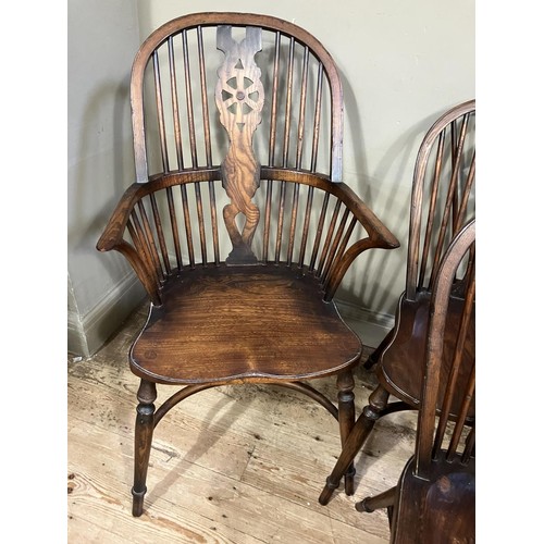 431 - A set of six wheel back dining chairs comprising two carvers and four singles