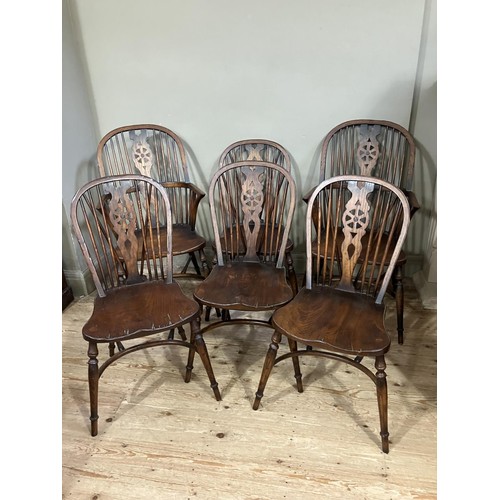 431 - A set of six wheel back dining chairs comprising two carvers and four singles