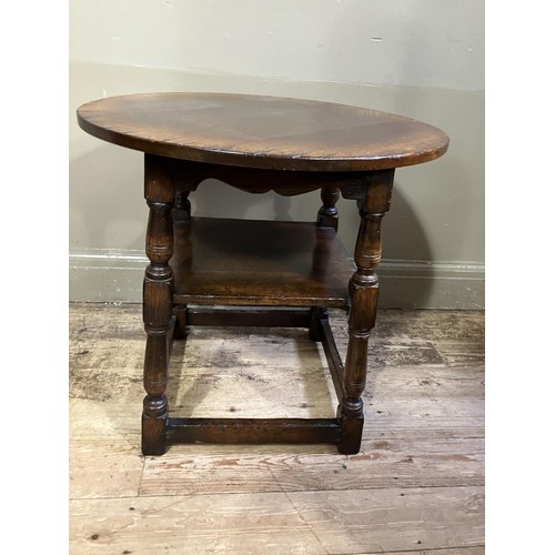 433 - A Titchmarsh and Goodwin oak occasional table, circular outline on turned legs joined by a square un... 